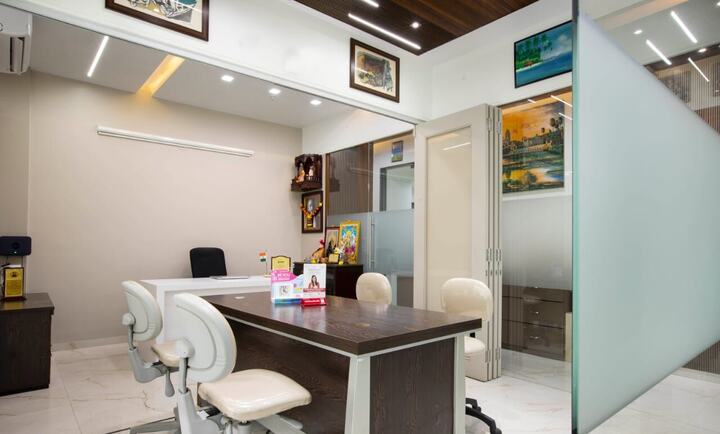A consultation room at the clinic, with a desk and chairs