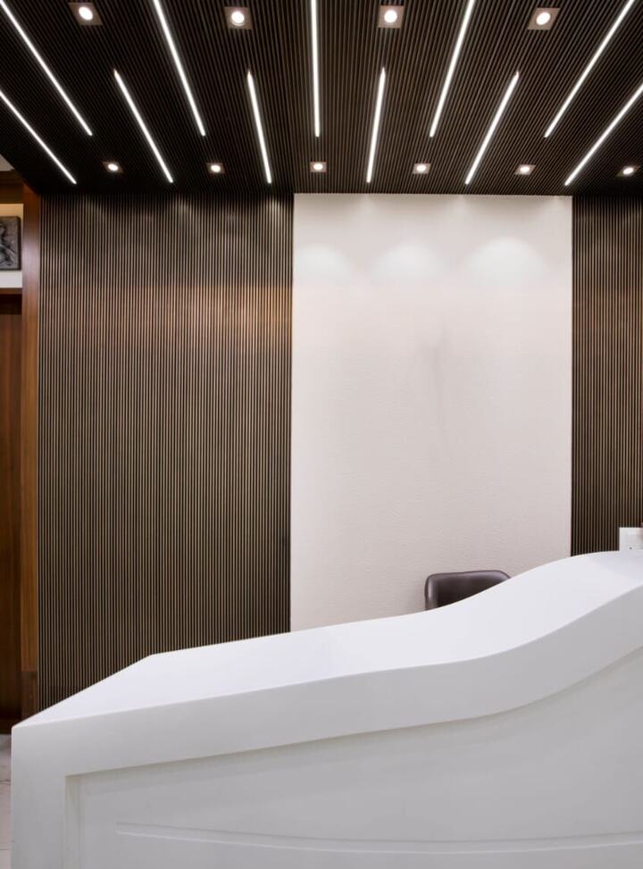 The reception desk at Swami Dental Clinic, with a lamp and a small arrangement of objects