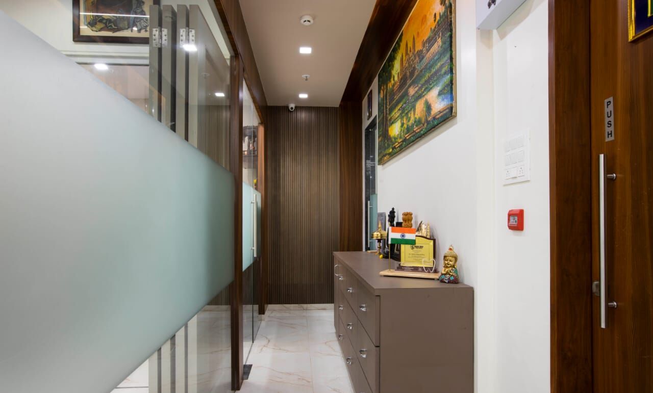 A corridor of frosted glass panels and dark wood, with framed landscapes on the wall